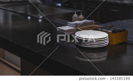 Dishes and condiments lined up on the counter of a restaurant Dishes and condiments lined up on the counter of a restaurant 143385199