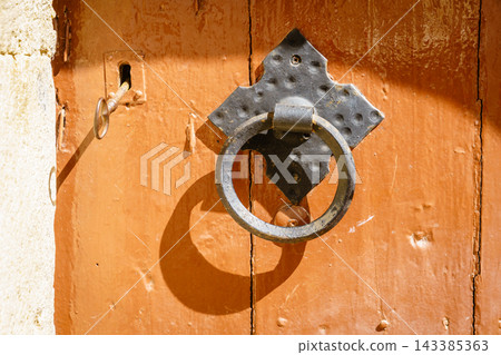 Antique door knocker detail with key and lock, Crete, Greece Antique door knocker detail with key and lock, Crete, Greece 143385363