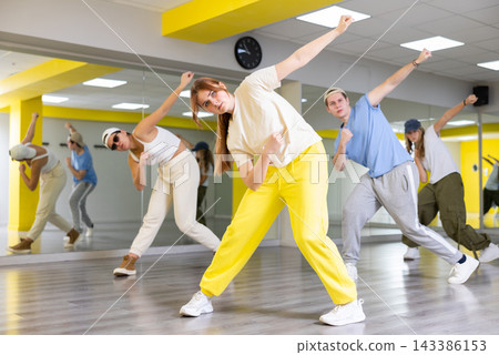 Young girl training breakdance Toprock moves in dance hall Young girl training breakdance Toprock moves in dance hall 143386153