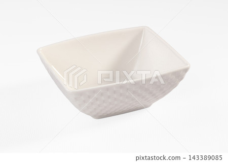 Empty white ceramic bowl with textured woven pattern and smooth glazed interior on white background, square dish for food serving Empty white ceramic bowl with textured woven pattern and smooth glazed interior on white background, square dish for food serving 143389085