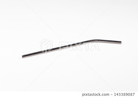Object studio shot of single metallic drinking straw on white background for zero waste lifestyle Object studio shot of single metallic drinking straw on white background for zero waste lifestyle 143389087