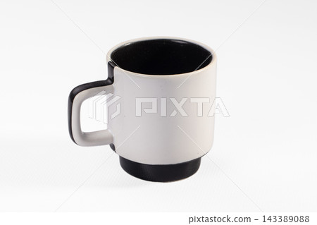 White ceramic mug with black handle and base on white background, kitchenware object White ceramic mug with black handle and base on white background, kitchenware object 143389088
