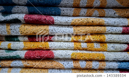 Stacked Colorful Curly Synthetic Door Mats Texture Background Close Up Stacked Colorful Curly Synthetic Door Mats Texture Background Close Up 143389334