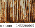 Texture or background of Rusted, aged galvanized sheet metal wall surface; weathered galvanized steel fence; retro concept; the artistry of old, rusty galvanized sheeting; vintage-style metal panels. 143390605
