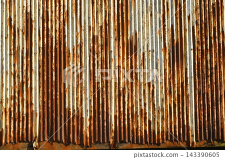 Texture or background of Rusted, aged galvanized sheet metal wall surface; weathered galvanized steel fence; retro concept; the artistry of old, rusty galvanized sheeting; vintage-style metal panels. 143390605
