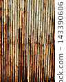 Texture or background of Rusted, aged galvanized sheet metal wall surface; weathered galvanized steel fence; retro concept; the artistry of old, rusty galvanized sheeting; vintage-style metal panels. 143390606