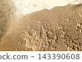 Texture or backgrond of stone wall shows signs. Weathered stone wall with visible signs of aging and erosion.  Due to exposure to elements.  Some areas show smoothness, indicating prolonged weathering 143390608