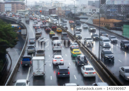 Heavy traffic driving on a wet elevated expressway during a gloomy rainy day in Bangkok, Thailand Heavy traffic driving on a wet elevated expressway during a gloomy rainy day in Bangkok, Thailand 143390987