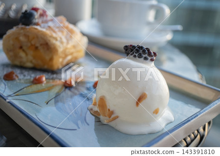 Gourmet mousse cake and puff pastry desserts served on a tray in a luxury cafe Gourmet mousse cake and puff pastry desserts served on a tray in a luxury cafe 143391810