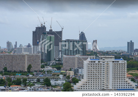 Urban development with high rise residential towers, apartment buildings, construction cranes, and new skyscrapers rising across expanding metropolitan district. Urban growth, real estate development. Urban development with high rise residential towers, apartment buildings, construction cranes, and new skyscrapers rising across expanding metropolitan district. Urban growth, real estate development. 143392294
