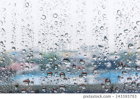 Raindrops and water condensation on glass windo 143393783