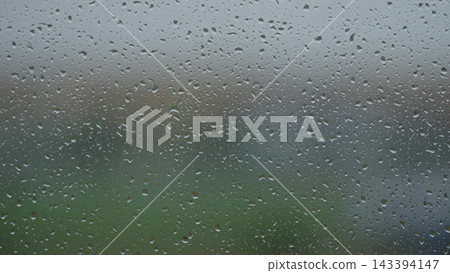 Rain drop hitting window glass and sliding down Rain drop hitting window glass and sliding down 143394147