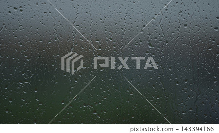 Rain drop hitting window glass and sliding down Rain drop hitting window glass and sliding down 143394166