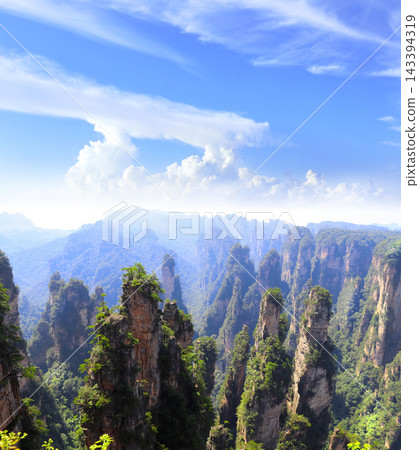 Majestic quartz sandstone pillars, Zhangjiajie National Park, China. Avatar Mountains, Wulingyuan scenic area, tourist attraction, Hunan. Towering peaks, tree, stunning karst landscape scenery view Majestic quartz sandstone pillars, Zhangjiajie National Park, China. Avatar Mountains, Wulingyuan scenic area, tourist attraction, Hunan. Towering peaks, tree, stunning karst landscape scenery view 143394319