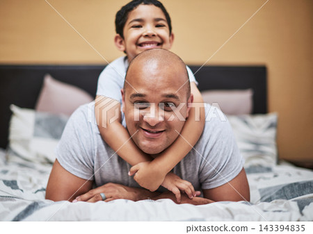 Portrait, father and son with love in bedroom for bonding with smile, family and home for development. Trust, people and caring with role model in house for nurturing with positive relationship. Portrait, father and son with love in bedroom for bonding with smile, family and home for development. Trust, people and caring with role model in house for nurturing with positive relationship. 143394835