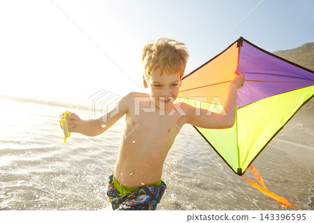 Excited child, running and kite on beach with adventure, fun and playing in sunshine for summer holiday. Happy boy or kid splashing in sea water or waves with game and wind for travel or vacation Excited child, running and kite on beach with adventure, fun and playing in sunshine for summer holiday. Happy boy or kid splashing in sea water or waves with game and wind for travel or vacation 143396595