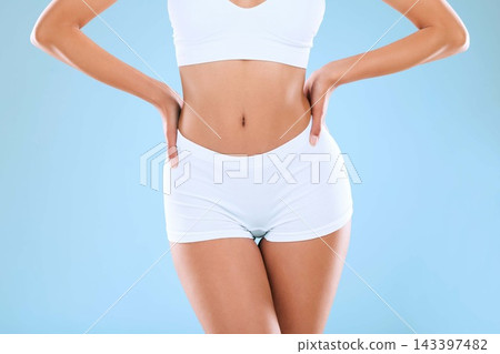 Fitness, health and abdomen of woman in studio with wellness, exercise and weightloss for slim body. Underwear, detox and female person with diet, training or workout for stomach by blue background. 143397482