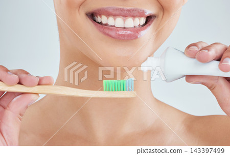Toothpaste, bamboo brush and woman in studio for plaque removal and cleaning treatment. Smile, dental health and female person with oral care product, mouth and teeth routine by white background. Toothpaste, bamboo brush and woman in studio for plaque removal and cleaning treatment. Smile, dental health and female person with oral care product, mouth and teeth routine by white background. 143397499