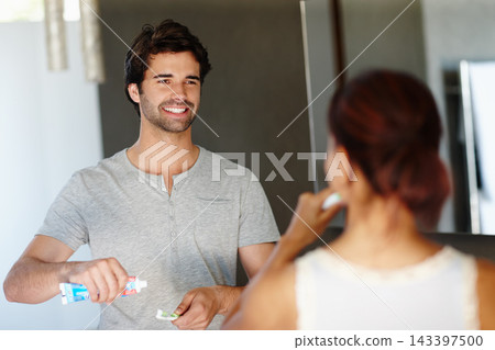 Love, happy couple and brushing teeth at home for dental, oral hygiene and routine with married people. Marriage, woman and man with mouth care, toothpaste and cleaning for wellness in bathroom Love, happy couple and brushing teeth at home for dental, oral hygiene and routine with married people. Marriage, woman and man with mouth care, toothpaste and cleaning for wellness in bathroom 143397500