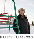 Portrait of a laughing mature man with eyes closed having fun at winter playground. 143397605
