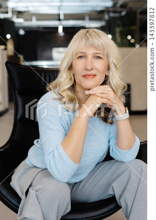 Confident Woman in Modern Office Setting Portrait Confident Woman in Modern Office Setting Portrait 143397812
