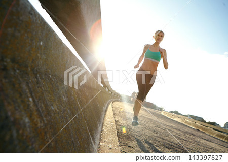Fitness, health and woman on bridge for running with race, marathon or endurance training. Sports, speed and female athlete runner with cardio workout by highway for outdoor wellness exercise. Fitness, health and woman on bridge for running with race, marathon or endurance training. Sports, speed and female athlete runner with cardio workout by highway for outdoor wellness exercise. 143397827