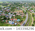 Aerial View of Rural Residential Area with Curving Road and Green Landscape 143398296