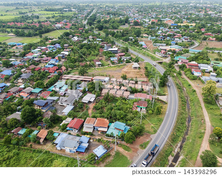Aerial View of Rural Residential Area with Curving Road and Green Landscape Aerial View of Rural Residential Area with Curving Road and Green Landscape 143398296