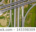 Drone shot a large highway interchange crossing over green farmlands in Thailand 143398309