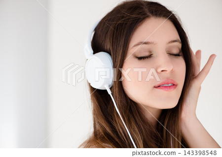 Girl, relax and headphones with music, listening and calm in enjoying, subscription or streaming. Female person, indoor and peaceful for radio, podcast or online for audio, headset and zen at home Girl, relax and headphones with music, listening and calm in enjoying, subscription or streaming. Female person, indoor and peaceful for radio, podcast or online for audio, headset and zen at home 143398548