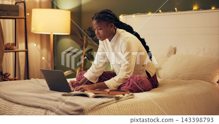 Education, laptop and night with black woman in bedroom at home for distance learning or remote study. Computer, notebook and research with college or university person on bed of apartment in evening Education, laptop and night with black woman in bedroom at home for distance learning or remote study. Computer, notebook and research with college or university person on bed of apartment in evening 143398793