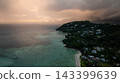 Beautiful sunset casting orange hues over multiple islands and calm ocean waters, with silhouetted hills. Seychelles, Mahe. 143399639