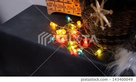 Vintage Christmas Lights Garland Glowing. Colorful String Lights on Dark Surface Vintage Christmas Lights Garland Glowing. Colorful String Lights on Dark Surface 143400049