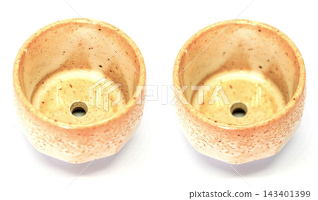 The ceramic cup has been adapted for planting small pot plants The ceramic cup has been adapted for planting small pot plants 143401399