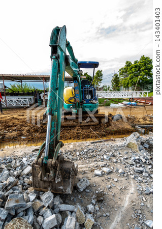 The excavator is demolishing the old building The excavator is demolishing the old building 143401403