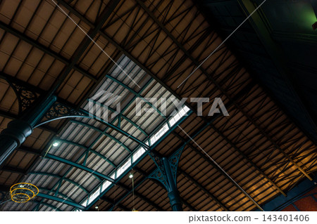 View up from the large hall, the steel frame of a large curved roof View up from the large hall, the steel frame of a large curved roof 143401406