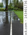 A park basketball court wet from the rain 143401736