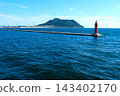 The red lighthouse at the entrance to Hakodate Port and Mount Hakodate. 143402170