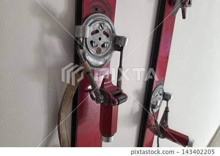 Vintage Ski Bindings on Red Skis - Classic Winter Sports Equipment Vintage Ski Bindings on Red Skis - Classic Winter Sports Equipment 143402205