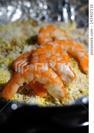 Peeled Korean salt-roasted prawns, Daeha-gui, neatly arranged on a bed of coarse salt Peeled Korean salt-roasted prawns, Daeha-gui, neatly arranged on a bed of coarse salt 143402516