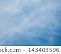 Clean atmosphere of a bright blue sky with a soft white cloud in the corner. Conceptual backdrop for global warming, climate change, green energy or clean air environment projects. Copy space 143403596