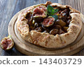 Fresh fig galette on wooden board with mint garnish 143403729