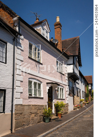 Old houses on Mill Street in Warwick, UK with one painted pink. Old houses on Mill Street in Warwick, UK with one painted pink. 143403964