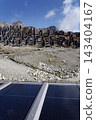 Solar panels lying on ground with vertically mounted four wings around central column, photovoltaic plant avoid snow accumulation, maintain high yields, Alps, future innovation energy concept 143404167