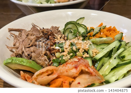 Fresh Korean Bibimbap Bowl with Vegetables and Meat for a Healthy Meal Presentation Fresh Korean Bibimbap Bowl with Vegetables and Meat for a Healthy Meal Presentation 143404875