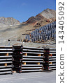 Solar panels lying on ground with vertically mounted four wings around central column, photovoltaic plant avoid snow accumulation, maintain high yields, Alps, future innovation energy concept 143405092