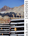 Solar panels lying on ground with vertically mounted four wings around central column, photovoltaic plant avoid snow accumulation, maintain high yields, Alps, future innovation energy concept 143405093