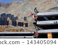 Solar panels lying on ground with vertically mounted four wings around central column, photovoltaic plant avoid snow accumulation, maintain high yields, Alps, future innovation energy concept 143405094