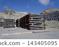 Solar panels lying on ground with vertically mounted four wings around central column, photovoltaic plant avoid snow accumulation, maintain high yields, Alps, future innovation energy concept 143405095