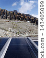 Solar panels lying on ground with vertically mounted four wings around central column, photovoltaic plant avoid snow accumulation, maintain high yields, Alps, future innovation energy concept 143405099